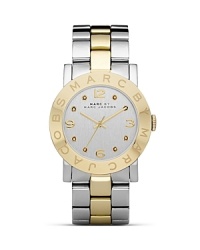 Put a distinctive duo-tone spin on your wrist wear collection with this watch from MARC BY MARC JACOBS. It's classic, gleaming style lends every look a timeless touch. Put a distinctive duo-tone spin on your wrist wear collection with this watch from MARC BY MARC JACOBS. It's classic, gleaming style lends every look a timeless touch.