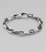 Bold oval links of polished sterling silver have not-so-sinister curved spikes in their centers.Sterling silver Length, about 8½ Lobster clasp Imported