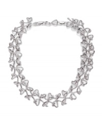 Elaborate elegance. An interlaced motif with an airy, linear aesthetic defines Swarovski's Lightness crystal collar necklace. Crafted in silver tone mixed metal, it's adorned with shimmering crystals. Approximate length: 13 inches + 2-inch extender. Elaborate elegance. An interlaced motif with an airy, linear aesthetic defines Swarovski's Lightness crystal collar necklace. Crafted in silver tone mixed metal, it's adorned with shimmering crystals. Approximate length: 13 inches + 2-inch extender.