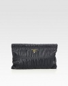 Supple leather in a signature ruched design.Back handle, 1 dropTop zip closureOne inside zip pocketTwo inside open pocketsLeather lining13W X 8½H X 1DMade in Italy
