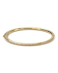The slender bangle from Nadri is crafted in polished 18 Kt. gold plate with a single-row of gleaming crystal pave to a bring a touch of light. The slender bangle from Nadri is crafted in polished 18 Kt. gold plate with a single-row of gleaming crystal pave to a bring a touch of light.