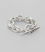 Bold links, subtly hammered, in shiny sterling silver with a chunky toggle closure. Sterling silver Length, about 8 Toggle closure Imported