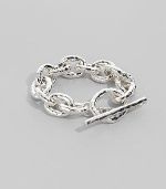 Bold links, subtly hammered, in shiny sterling silver with a chunky toggle closure. Sterling silver Length, about 8 Toggle closure Imported