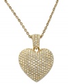 Refined and romantic. Swarovski's puffed heart pendant stands out stylishly on this stunning necklace. Adorned with sparkling clear pavé crystals, it's crafted in gold tone mixed metal and includes a foldover clasp. Approximate length: 32 inches. Approximate drop: 1 inch.