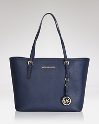 While slightly smaller in scale, this MICHAEL Michael Kors' tote maintains first class allure, crafted of subtly textured leather. Its soft, structured shape opens to an interior with 2 pockets. While slightly smaller in scale, this MICHAEL Michael Kors' tote maintains first class allure, crafted of subtly textured leather. Its soft, structured shape opens to an interior with 2 pockets.