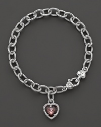 A faceted raspberry crystal heart charm decorates a classic bracelet from Judith Ripka. A faceted raspberry crystal heart charm decorates a classic bracelet from Judith Ripka.