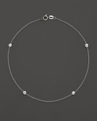 Diamond bezels sparkle from the stations on this dainty 14K white gold ankle bracelet. Diamond bezels sparkle from the stations on this dainty 14K white gold ankle bracelet.