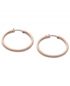 Non-stop glitz from Fossil. These classic hoop earrings embrace modern trends with rosy hues and pave crystal accents. Crafted in rose-gold tone mixed metal. Approximate diameter: 1-3/8 inches.