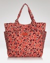 A favorite MARC BY MARC JACOBS tote is updated for this season in a pretty print, styled for daytime accessorizing with knotted top handles and a haul-it-all shape.