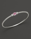 Two hearts flank a cushion-cut pink corumdum on this slim bangle.