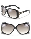 Black oversized sunglasses with faux snakeskin inlay and studded detail at temples, an edgy style from Jimmy Choo.
