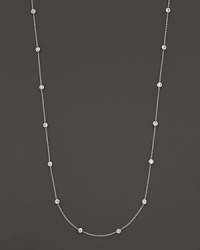 A long white gold chain is spaced with fifteen bezel-set, diamond stations. A long white gold chain is spaced with fifteen bezel-set, diamond stations.