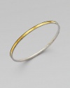 From the Lancelot Collection. Thoroughly modern and thoroughly stunning, this slender bangle of hammered sterling silver is encircled by a gleaming band of 24k gold.Sterling silver and 24k yellow goldDiameter, about 2½Imported