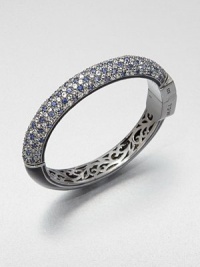 Half of this shimmering bangle is encrusted with gemstones in icy cool colors, the other half is finished in sleek enamel, and inside is lovely, lacy openwork.Blue sapphire, white topaz and blue topazEnamelBlack rhodium-plated sterling silverDiameter, about 2.2Hinged with push-lock claspImported