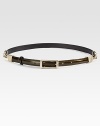 Shiny glazed leather, fastened with a square buckle and accented with goldtone chain details.About ½ wideLeatherMade in Italy of imported fabric