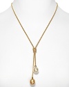 A delicate gold necklace with Lariat knot and double man-made pearl pendant. Designed by Majorica.