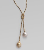 A lariat of rope-textured 18k gold vermeil with a love knot center and lustrous white and champagne baroque organic pearls dangling from each end. 14mm baroque white and champagne man-made pearls 18k gold vermeil Length adjusts from about 18 to 24 Made in Spain