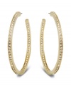Star-studded style. This elegant pair of gold tone hoop earrings sparkles in clear Swarovski crystal pavé, reflecting the light beautifully and adding a touch of sophistication to any outfit. Approximate diameter: 1-7/8 inches.