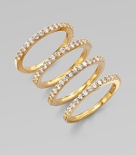 A set of four goldtone rings accented with sparkling cubic zirconia. Goldtone brassCubic zirconiaWidth, about ¼ when worn togetherImported 
