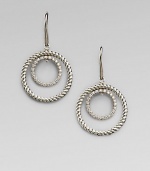 A circle of cabled sterling silver surrounds a sparkling pavé diamond-encrusted inner loop in these dangling earrings with a mobile-like design. Diamonds, 0.31 tcw Sterling silver Drop, about ¾ Ear wire Imported