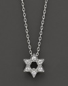From the Tiny Treasures collection, a Star of David necklace makes a religious statement; with signature ruby accent. Designed by Roberto Coin.