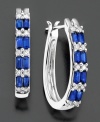 Baguette-cut sapphire (1-3/8 ct. t.w.) and round-cut diamond (1/4 ct. t.w.) alternate for a stunning effect on these 14k white gold hoop earrings. Approximate length: 3/4 inch. Approximate diameter: 1/2 inch.