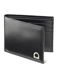 In fine Italian leather unsurpassed, Salvatore Ferragamo has created the Gancio billfold. A modern wallet with metal Gancini logo on front. Multiple card slots in the interior. In fine Italian leather unsurpassed, Salvatore Ferragamo has created the Gancio billfold. A modern wallet with metal Gancini logo on front. Multiple card slots in the interior.