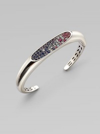 From the Eclipse Collection. A graceful oval paved with an array of faceted gemstones sits within a sleek hinged cuff of polished sterling silver.Blue sapphires, sky blue topaz, iolite and rhodoliteSterling silverHingedDiameter, about 2½Imported