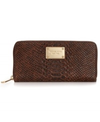 MICHAEL Michael Kors brings a touch of the exotic to the everyday with this python-embossed leather wallet, featuring signature-embossed hardware and slim, sophisticated shape. Slip it in your handbag or wear it on its own, for a wildly alluring way to stay organized. MICHAEL Michael Kors brings a touch of the exotic to the everyday with this python-embossed leather wallet, featuring signature-embossed hardware and slim, sophisticated shape. Slip it in your handbag or wear it on its own, for a wildly alluring way to stay organized.