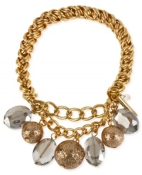 Eclectic elegance. Kenneth Cole New York's half stretch bracelet, crafted from gold-tone mixed metal, brings together gold-colored glitter and faceted oval beads to stunning effect. Item comes packaged in a signature Kenneth Cole New York Gift Box. Approximate diameter: 2-1/2 inches. Eclectic elegance. Kenneth Cole New York's half stretch bracelet, crafted from gold-tone mixed metal, brings together gold-colored glitter and faceted oval beads to stunning effect. Item comes packaged in a signature Kenneth Cole New York Gift Box. Approximate diameter: 2-1/2 inches.