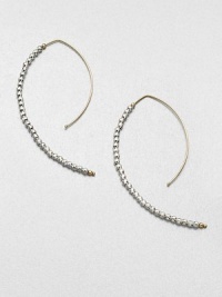 Delicate faceted sterling silver beads line up along the golden arc of an artfully shaped hoop with a modern appeal.14k yellow gold and sterling silverLength, about 2Hoop wireMade in USA Delicate faceted sterling silver beads line up along the golden arc of an artfully shaped hoop with a modern appeal.14k yellow gold and sterling silverLength, about 2Hoop wireMade in USA