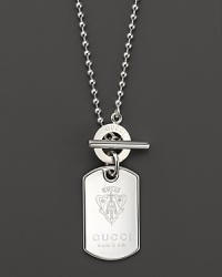 The Gucci crest adds a touch of fashion royalty to this sterling silver dogtag necklace, finished with a toggle clasp. The Gucci crest adds a touch of fashion royalty to this sterling silver dogtag necklace, finished with a toggle clasp.