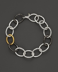 New developments in elegance. Links in hammered 24 Kt. yellow gold, dark and light silver set Gurhan's hoopla bracelet apart. New developments in elegance. Links in hammered 24 Kt. yellow gold, dark and light silver set Gurhan's hoopla bracelet apart.