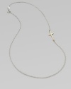 A simple, sleek cross of 14k gold sits sideways within a delicate sterling silver chain in this eloquent design.14k yellow gold and sterling silverLength, about 18Spring ring claspMade in USA