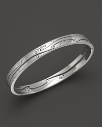 Scattered diamonds sparkle on this modern white gold bangle from Georg Jensen. Scattered diamonds sparkle on this modern white gold bangle from Georg Jensen.