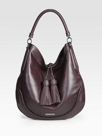 A mix of smooth and pebbled leather with beautiful stitched details throughout and two large tassel embellishments.Top handle, 5 dropMagnetic snap closureOne inside zip pocketTwo inside open pocketsCotton lining14W X 13¼H X 2DImported A mix of smooth and pebbled leather with beautiful stitched details throughout and two large tassel embellishments.Top handle, 5 dropMagnetic snap closureOne inside zip pocketTwo inside open pocketsCotton lining14W X 13¼H X 2DImported