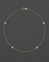 Diamond bezels sparkle from the stations on this dainty 14K white gold ankle bracelet.