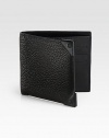 A simple bi-fold design receives a remarkably modern update, featuring six card slots and a billfold compartment, finished in textured, eel-embossed leather with silver accents.One billfold compartmentSix card slotsLeather5W x 4HImported