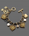 Accessorize with a little jungle love. This Betsey Johnson charm bracelet features leopard heart charms, crystal accents and imitation pearls set in goldtone mixed metal. Approximate length: 7 inches. Approximate charm drop: 1 inch.