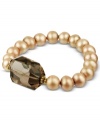 Turn up your elegance factor. This gorgeous stretch bracelet combines light champagne-colored cultured freshwater pearls (8-9 mm) with a chunky faceted smokey quartz (23-3/4 ct. t.w.). Set in 18k gold over sterling silver. Approximate length: 7-1/2 inches.