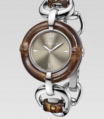 From the Bamboo Collection. This nature-inspired style features beautiful bamboo details mixed with sleek stainless steel. Swiss quartz movementWater resistant to 3 ATMRound stainless steel case, 35mm (1.4) Bamboo accented bezelBrown sun-brushed dialBar and Roman numeral hour markers at 3, 6, 9 and 12Bamboo accented stainless steel bangleMade in Switzerland Please note: Bamboo accents are not water resistant.