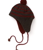 Paul Smith offers up this earthy striped hat, accented with a pom pom on top, contrast earflaps and braided ties at the chin.