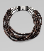 Beautifully textured, wooden beads with a sprinkle of rhinestone encrusted beads on leather cords in a chunky multi-row design. WoodLeatherBrassGlass stonesLength, about 20Logo accented turn-lock closureImported 