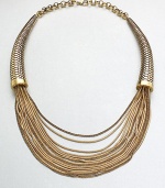 This unique statement piece features a mix of link and snake chains in a multi-row style with textured, horn-shaped endcaps. Antique-finished goldtoneLength, about 17Lobster clasp closureImported 