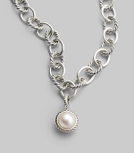 A lustrous white cultured pearl in a graceful cable frame makes an elegant addition to your own necklace or bracelet. White cultured pearl Sterling silver Diameter, about ½ Spring clip clasp Imported Please note: Necklace sold separately.