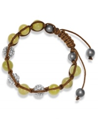 Spiritual-inspired bracelets are all the rage this season! Snap up this hot style from Ali Khan featuring semi-precious jade beads and pave glass fireballs on a trendy brown cord. Bracelet adjusts to fit the wrist. Approximate diameter: 2 inches. Approximate length: 12-1/4 inches.