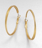 A simply chic piece with two textured rings, intertwined together in a radiant goldtone finish. GoldtoneLength, about 1.8Hinged post backImported 
