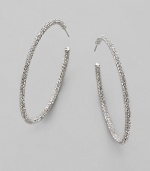 EXCLUSIVELY AT SAKS. Large, luxurious hoops, accented with the shimmer of pavé crystals. Crystals Rhodium plated Diameter, about 2¼ Stainless steel post back Imported