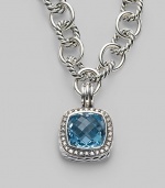 A sparkling faceted blue topaz, surrounded by pavé diamonds, sits in a squared setting of sterling silver with a cabled edge and fluted bale. Blue topaz Diamonds, 0.45 tcw Sterling silver with a black rhodium finish About ¾ square Spring clip clasp Made in USA Please note: Necklace sold separately.