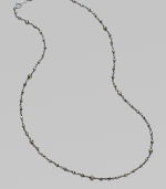 A long, elegant chain of oxidized sterling silver is richly dotted with rough pyrite beads.Pyrite Oxidized sterling silver Length, about 18 Spring ring clasp Made in USA